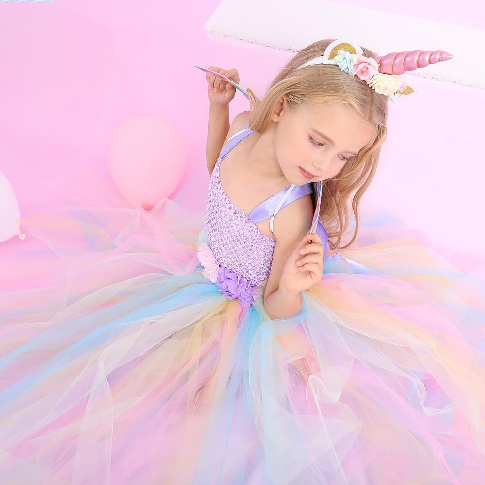 Babelio unicorn princess dress for kids with pastel tulle, photographed in a pink party room