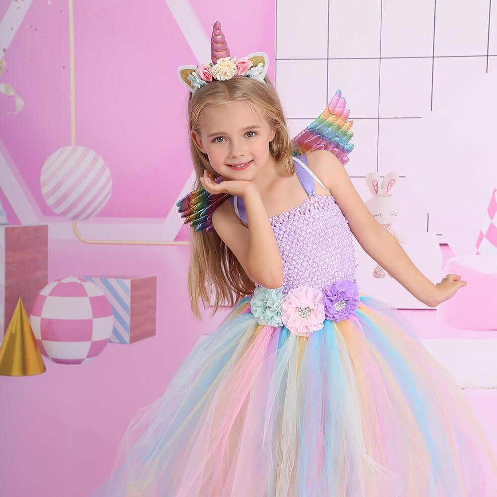 Babelio pastel unicorn dress for kids with rainbow wings in playful pink party setting