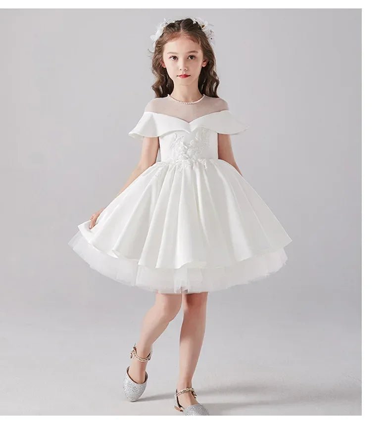 Babelio elegant flower girl in white formal dress, pearl necklace, in studio setting