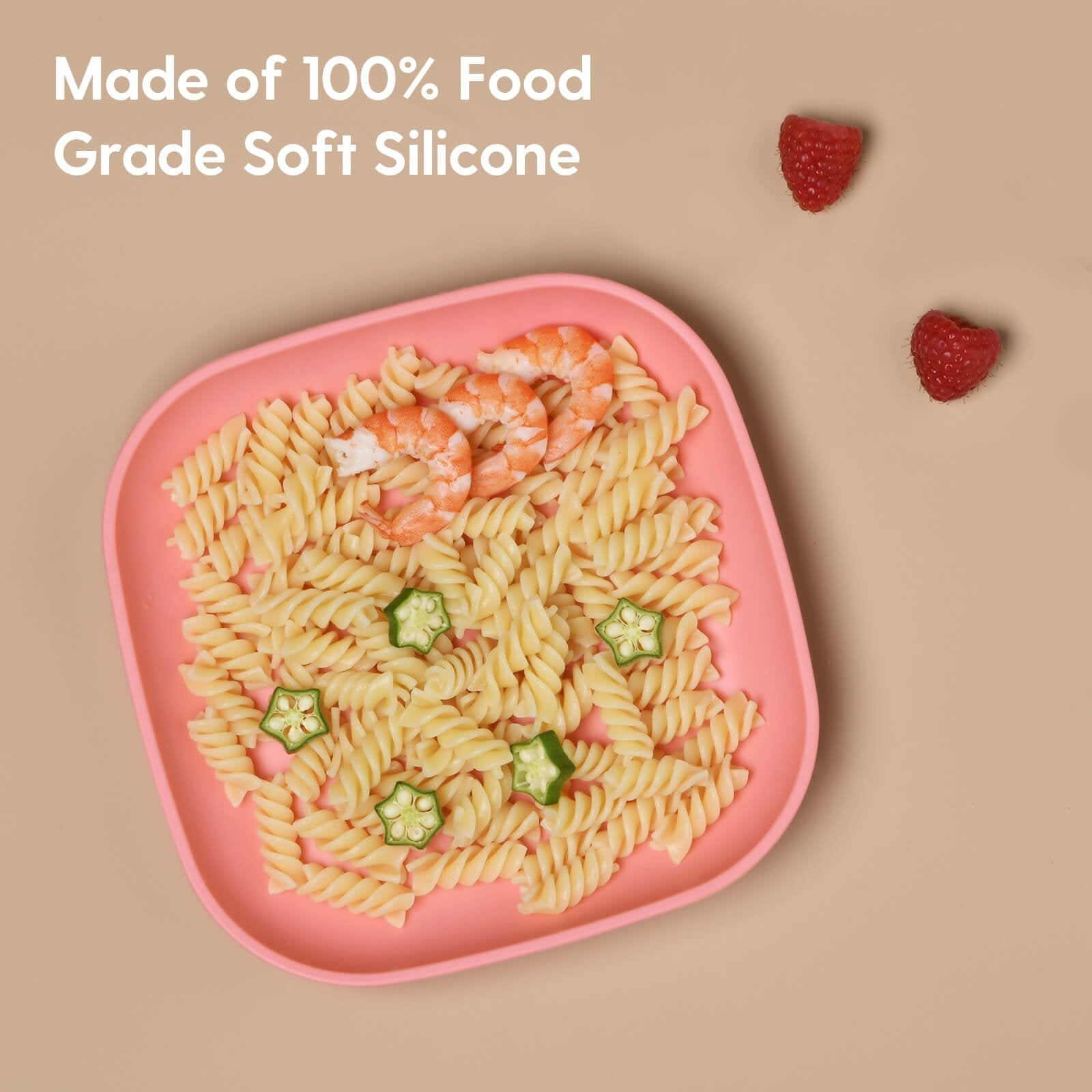 Babelio pink silicone toddler plate with pasta, shrimp, and okra on beige surface